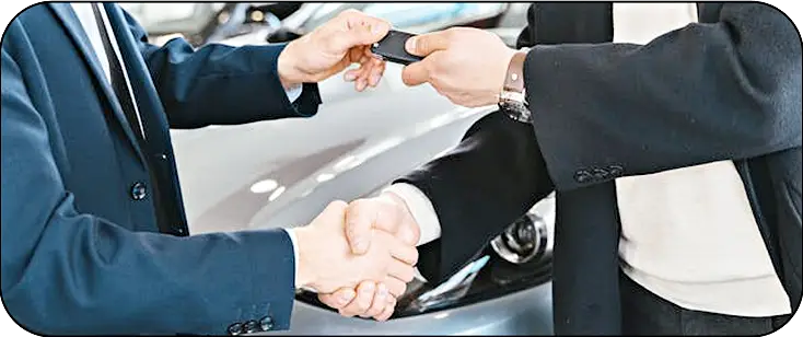 image of someone sitting inside a car—smilling while he being drived